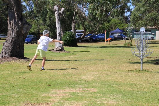 A young boy playing frisbee golf.