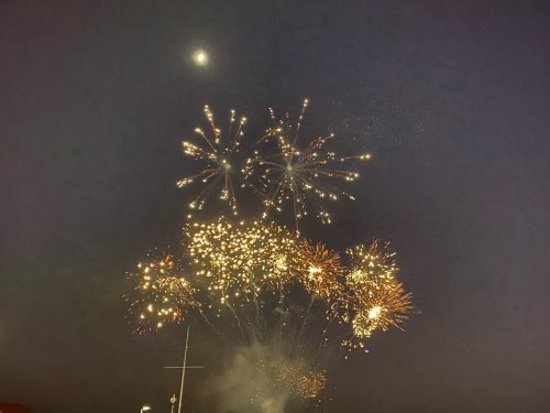 A burst of different fireworks in the sky at Cowes New Years Eve fireworks display. Multiple fireworks exploding.
