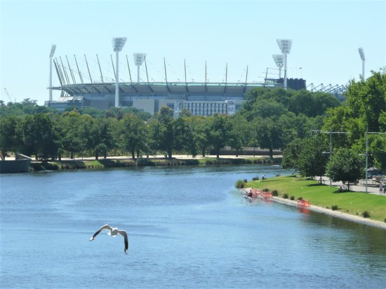 Melbourne's Yarra River, with the Melbourne Cricket Ground in the background. The Melbourne Cricket Ground near the Yarra River, Melbourne