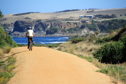 A cyclist on the Bass Coast Rail Trail. A cyclist approaching Kilcunda on the Bass Coast Rail Trail.