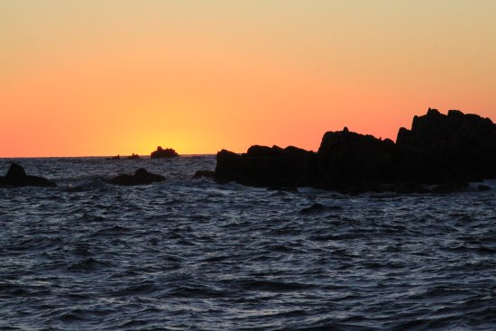 Sunset over the sea with rocks in the mid distance. Stunning sunset seen from Shearwater Cruise off Phillip Island