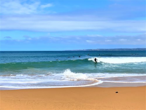 Surfers in the water at Flynns Beach, Phillip Island.