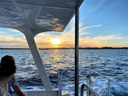 Wildlife Coast Twilight Bay Cruise passengers watching the sun set over Westernport Bay.
