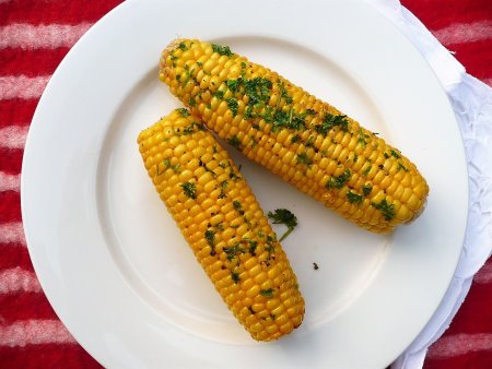 Grilled cobs of corn straight from the barbeque.