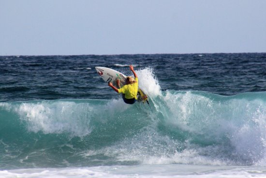 Surfing at Woolamai Beach. A surfer at Woolamai Beach, Phillip Island.