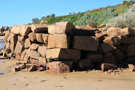 Wall of granite blocks at the old granite quarry at Cape Woolamai, Phillip Island.