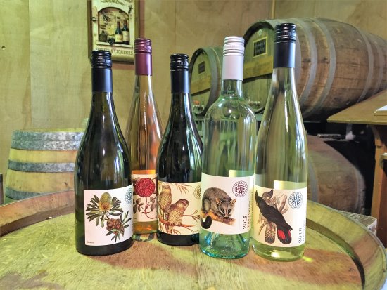 Bottles of wine on a barrel. A selection of wines from Gippsland Wine Company, Loch