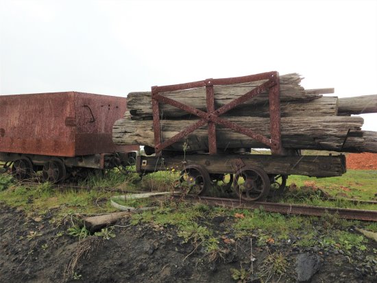 Old railway carriages with logs at the State Coal Mine, Wonthaggi. Rusty railway structures at the old Wonthaggi Coal Mine, Gippsland, Victoria