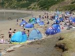 Beach scene with lots of blue sun tents